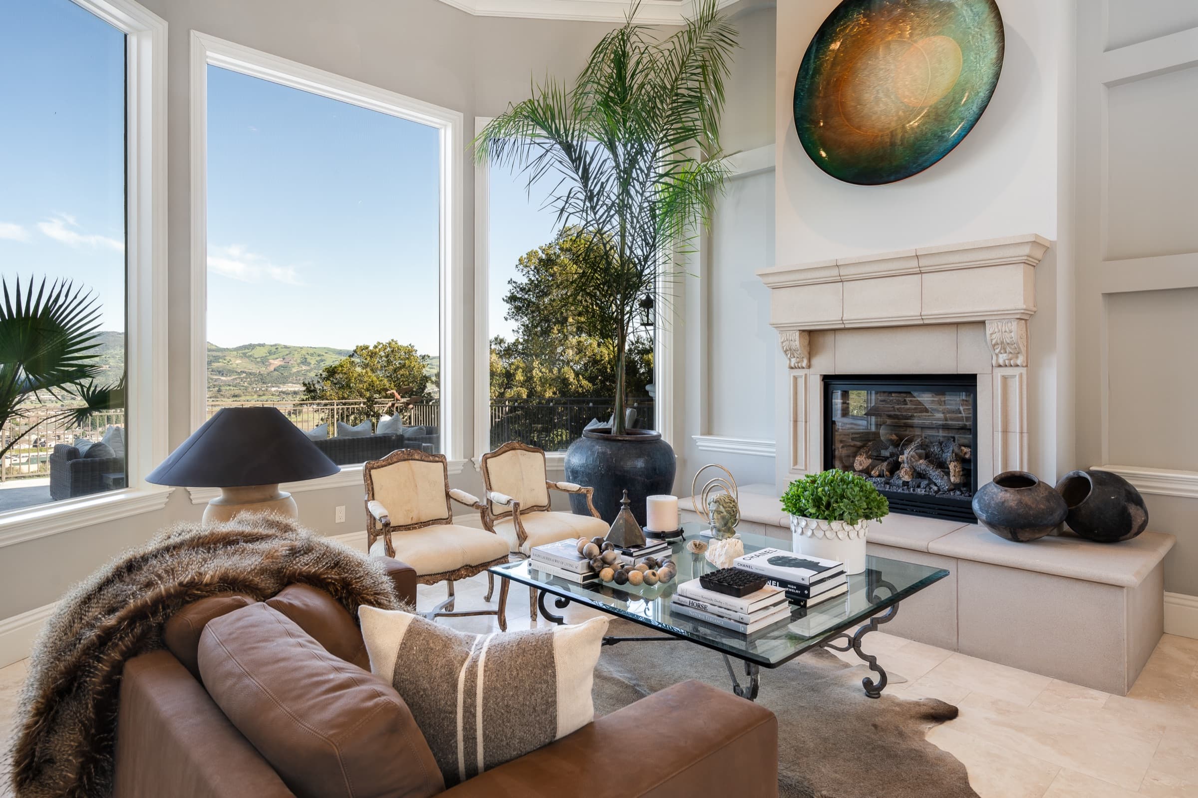 The vaulted living room with its stone fireplace and valley view.