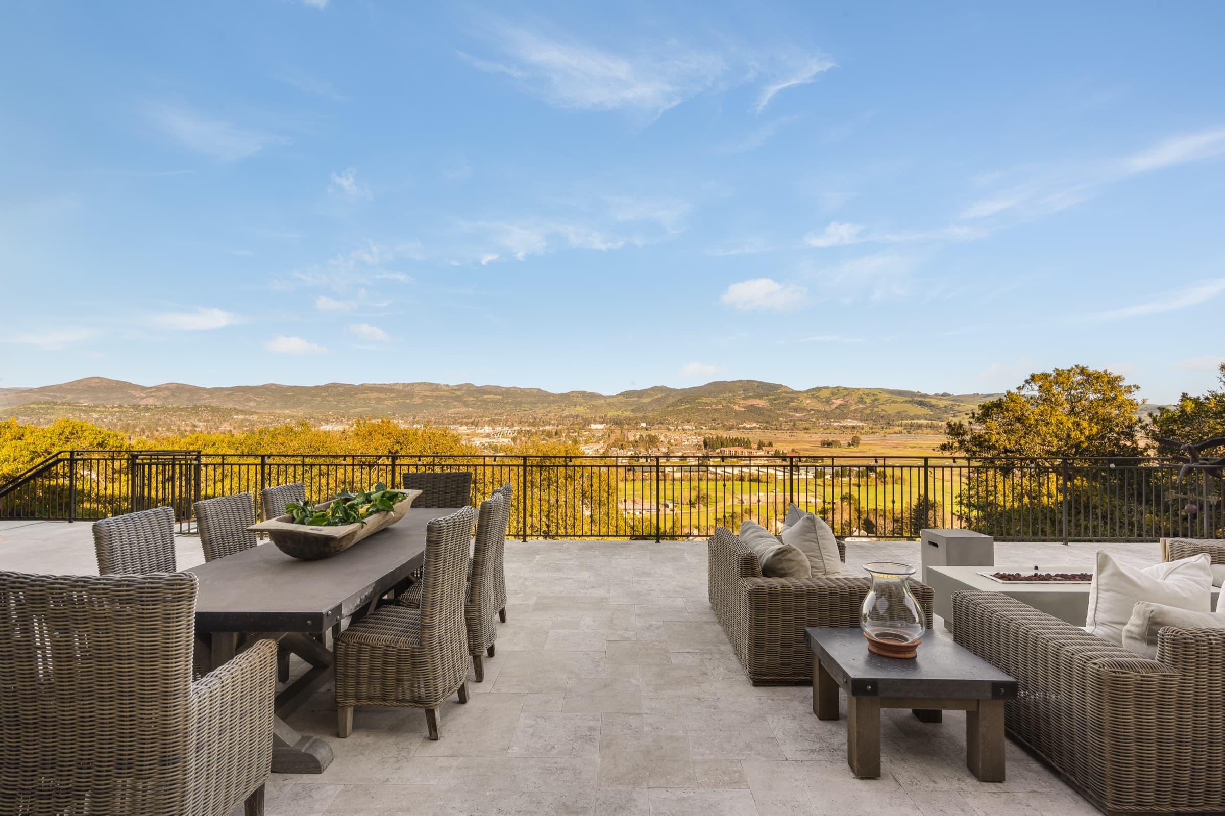 Dining and lounge areas on the stone deck overlooking the valley.